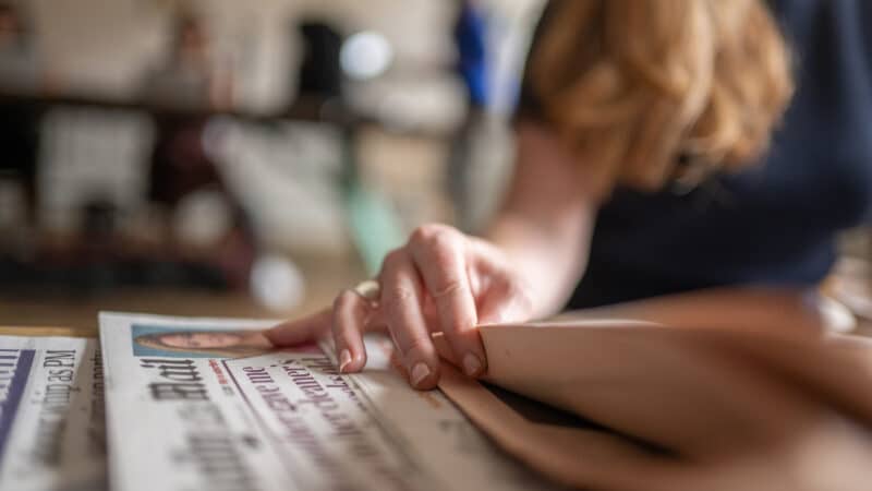 Turning some newspaper pages